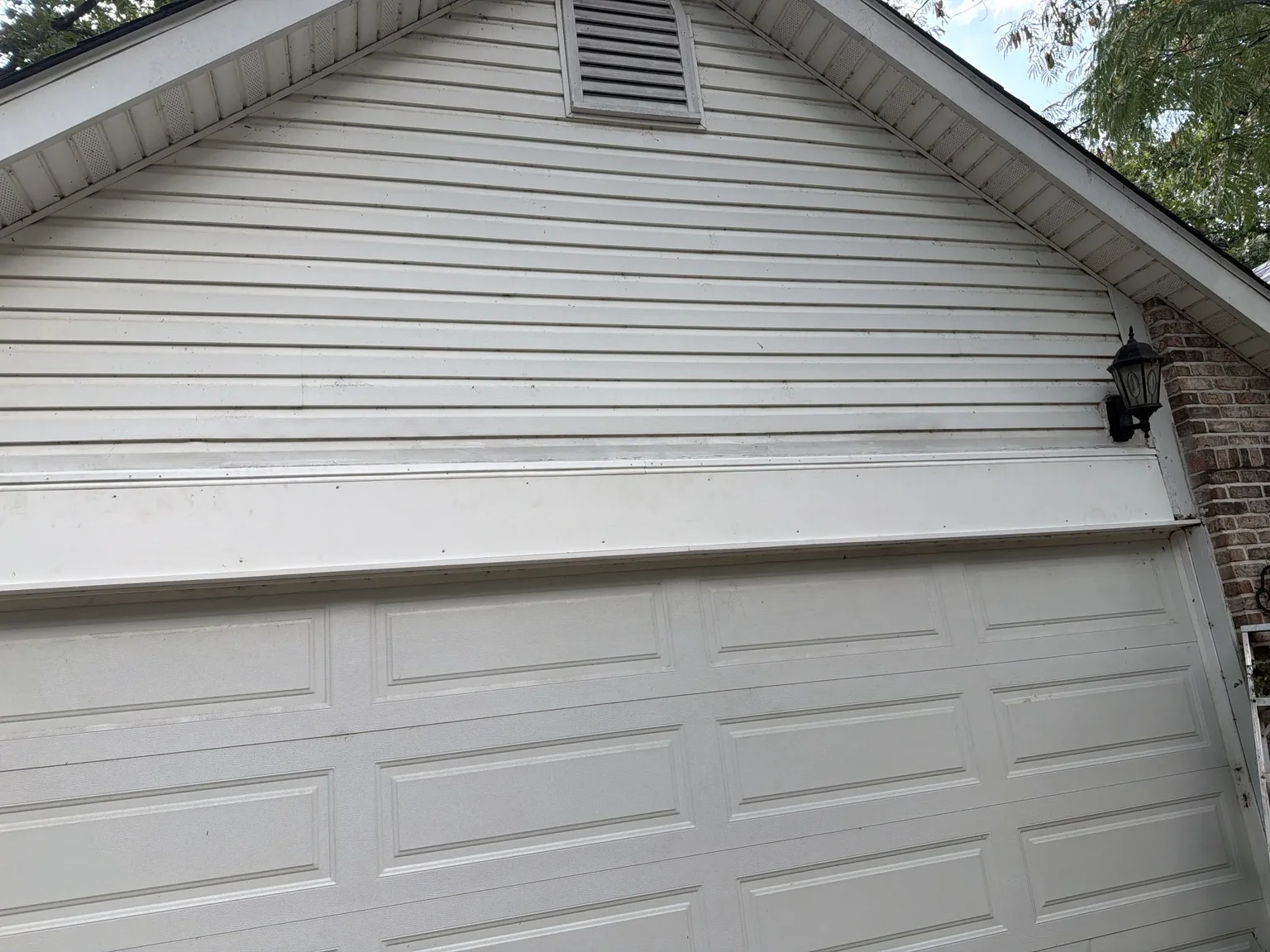 Finished white trim above a garage door