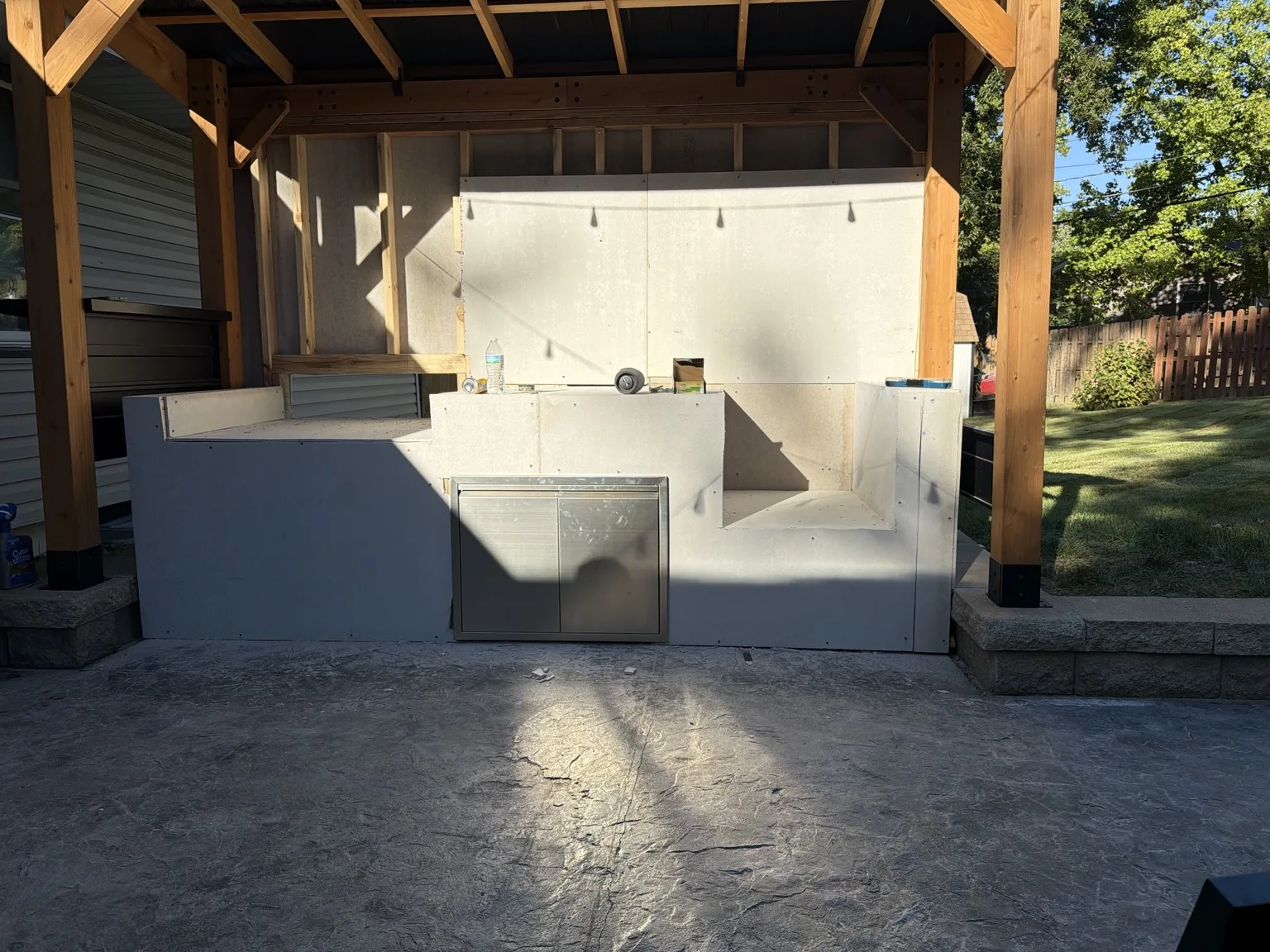 Outdoor kitchen beneath a timber patio cover